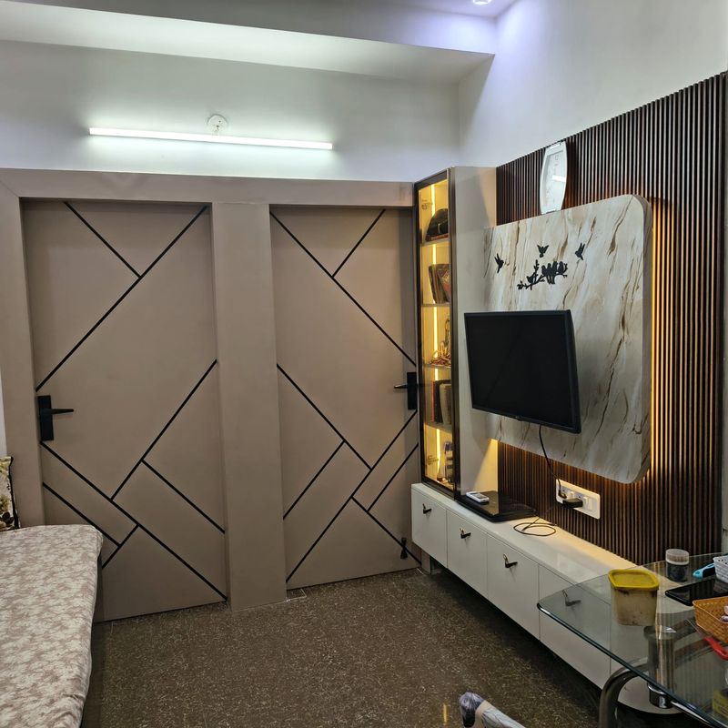 Bedroom wardrobe with grooved shutters beside a media panel.