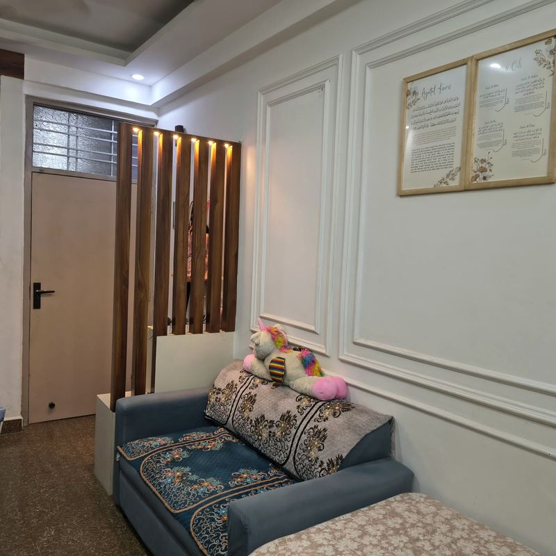 Lounge with white moulded wall panelling and a slatted screen.
